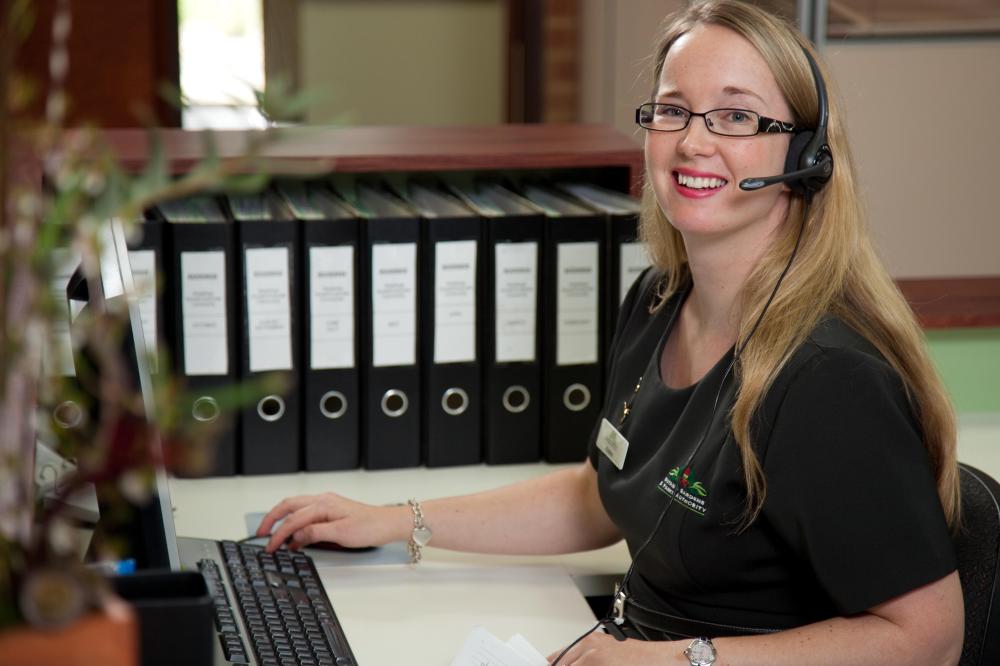 Receptionist smiling.