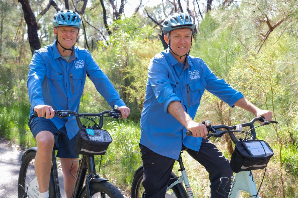 Two men on bikes.