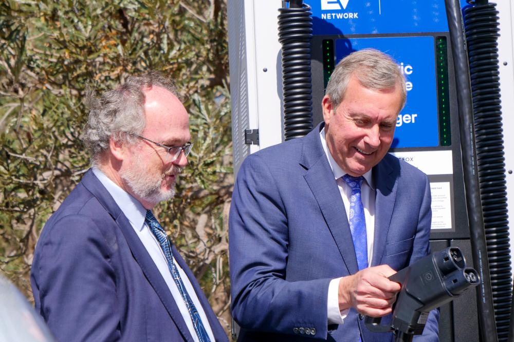 Two Ministers charging an electric vehicle.