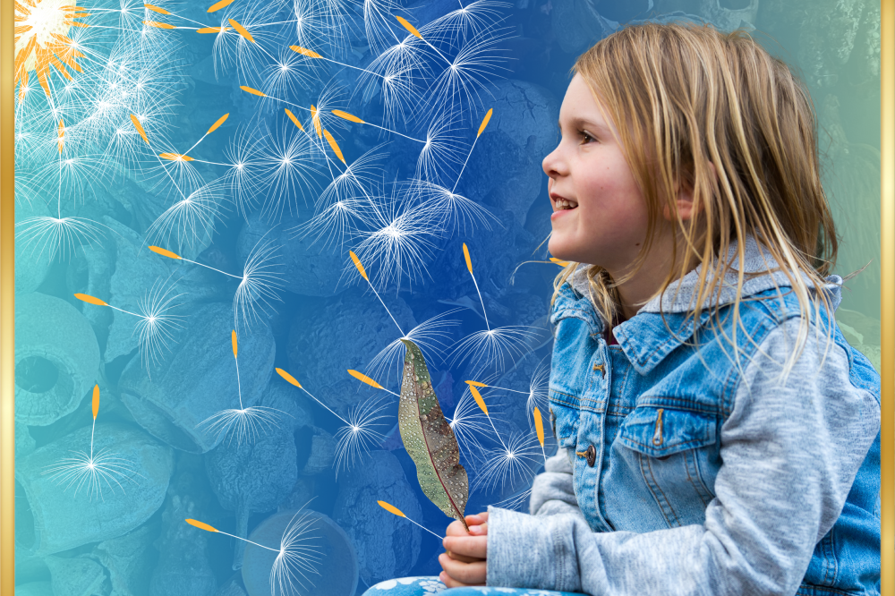 Young girl holding a feather.