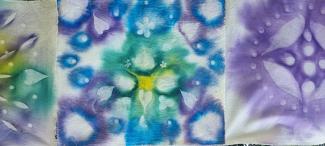 Dyed cloth in blue, purple and green.