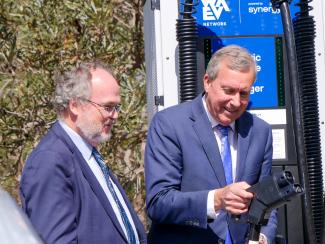 Two Ministers charging an electric vehicle.