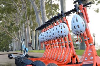 Orange E-scooters parked on Fraser Avenue